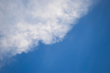 Naklejka na ściany i meble Gentle white clouds in a bright blue sky