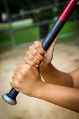 Close-up of Baseball Equipment including batter holding bat at park in Central Florida