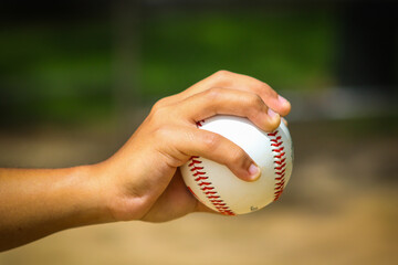 Close-up of person holding baseball hand closed on ball from side in Central Florida