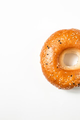 Fresh and delicious bagel with sesame on a white background with space for text. Creative concept of baking and bakery