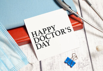 happy doctor's day words on white sticker and stethoscope