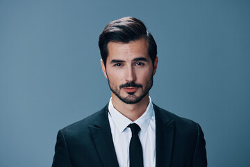 Man with beard brunette business suit jacket white shirt and tie poses on blue background. Business style clothing