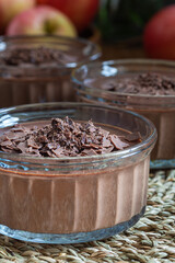 Chocolate Panna Cotta dessert in glass ramekin, harvest low key background, closeup