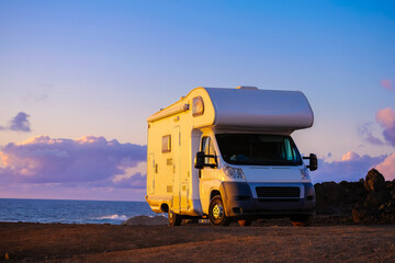 Camper van on the beach at sunset
