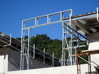 MELAKA, MALAYSIA - SEPTEMBER 16, 2022: Installation of the aluminum cladding frame at the end of the roof is underway. The metal decking roof system is equipped with a heat-resistant silsalation layer