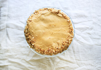 napoleon cake, round whole with caramel cream on a white background. copy space