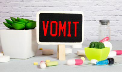 vomit word written on wood block. vomit text on wooden table for your desing, coronavirus concept top view