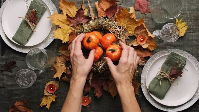 Thanksgiving Table Set For Holiday Feast. Woman Decorates Festive Dinner Table.