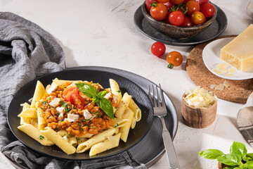 Tasty appetizing classic italian penne pasta with vegetarian lentil bolognese sauce, cheese...