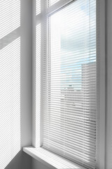 Fototapeta premium Stylish window with horizontal blinds in room