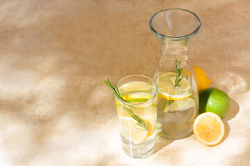 Tasty refreshing lemonade and ingredients on light table, space for text. Summer drink