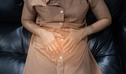 asian women stomachache, hand on stomach
