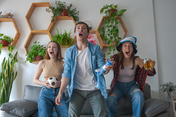 Three friends, celebrating and shouting that their soccer team scored a goal. - obrazy, fototapety, plakaty