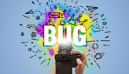 Close-up of a hand holding digital camera with abstract drawing
