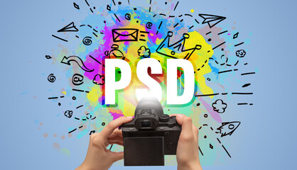 Close-up of a hand holding digital camera with abstract drawing