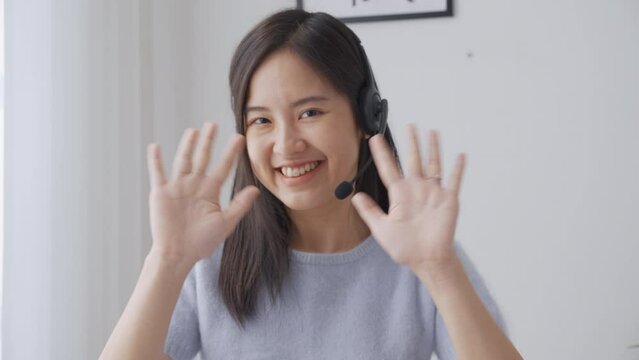 Young asian businesswoman wearing headset video call and presentation for conference online at home, woman meeting and talking for present, one person, business and communication concept.