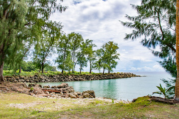 Tropical beach, sand, trees and blue green ocean in Angaur island, Palau, Pacific