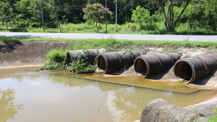 Concrete drainage pipes on the side of the road. Four sets of old concrete pipes for draining...