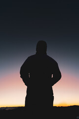 silhouette of a person watching the sunrise