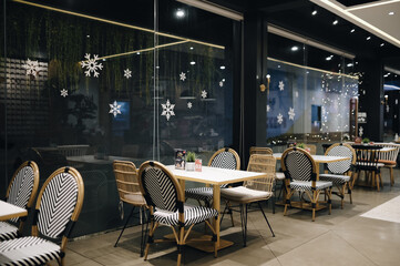 Christmas decration ornamental for family restaurant. Combined artificial red flower, tree and plants. Seasonal decoration. Starry light tree. 