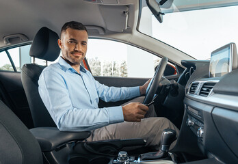 Young businessman in a car rental service. Test drive concept