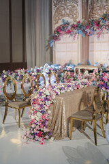 Wedding decoration with multi colors flowers and modern design table setting. Intimacy wedding ceremony or party indoors. 