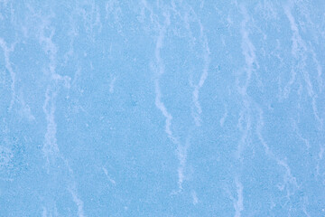 Texture of winter ice surface. Blue natural ice background