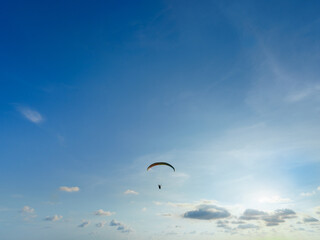 Paragliding in Phuket, Thailand. Extreme sport activity excited air adventure for tourist. Pilot floating in sky float with wind, enjoy freedom a hobby on vacation. Leave free space for text input.