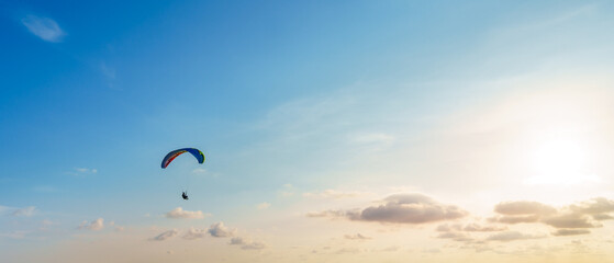 Paragliding in Phuket, Thailand. Extreme sport activity excited air adventure. Pilot floating in the sky float with wind, enjoy freedom a hobby on vacation. Leave free space for banner text input.
