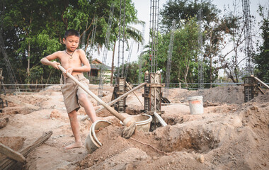 Poor children at the construction site were forced to work. Concept against child labor. The oppression or intimidation of forced labor among children. Human trafficking.