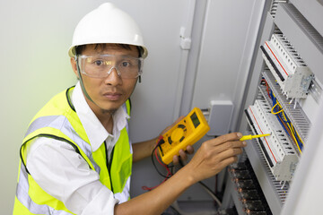 Male engineer checking electrical system with electronic equipment