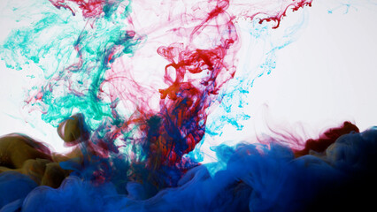 Abstract formed red, blue, green color dissolving water. Abstract cloud ink swirling water. High-quality stock photo Acrylic ink underwater form, abstract smoke pattern isolated on white background