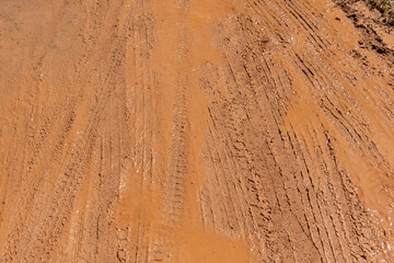 Wet muddy dirt wheel imprinted road