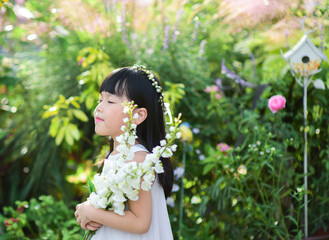 Smiling little girl holding flowers