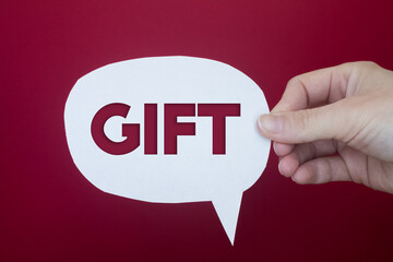 Speech bubble in front of colored background with Gift text.