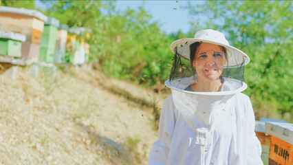 Portrait of a female beekeeper in a field