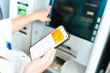 Online payment. Woman holding smartphone with internet online bank application. Debit card wallet...