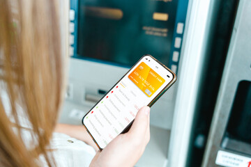 Internet based banking. Girl holding mobile phone with internet online bank app. Credit card wallet application. Online wallet save money.