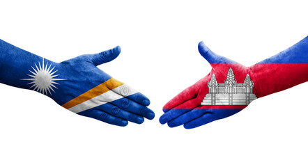 Handshake between Cambodia and Marshall Islands flags painted on hands, isolated transparent image.