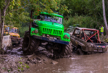 The car overcomes difficult obstacles. Large-scale sports competitions of off-road cars "TVER KNEADING: RACE OF TITANS" in the "Pavlov Adventure Park" in Tver. August 12, 2022.