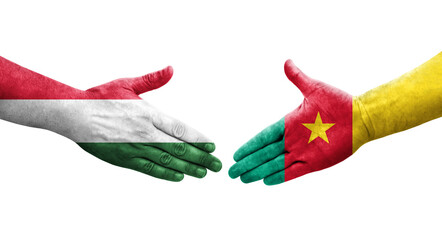 Handshake between Cameroon and Hungary flags painted on hands, isolated transparent image.