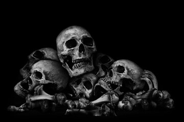 Awesome pile of skull human and bone on black cloth background, concept of scary crime scene of horror or thriller movies,Halloween theme, Still Life style, selective focus, - obrazy, fototapety, plakaty