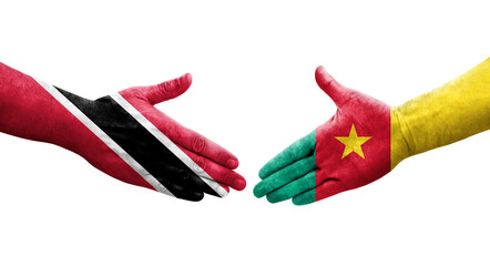 Handshake between Cameroon and Trinidad Tobago flags painted on hands, isolated transparent image.