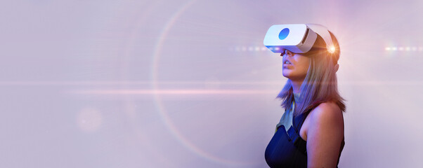 Woman is using virtual reality headset. Concept of virtual, augmented and extended reality and metaverse.