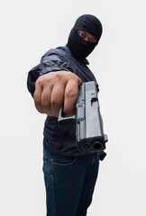 Burglar or terrorist. Holding pistol in various poses on background isolated with clipping path.