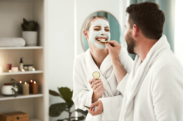 Happy couple playful, facial and relax at spa for wellness, skincare, love together and eating...