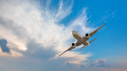 White passenger airplane flying in the sky amazing clouds in the background - Travel by air transport