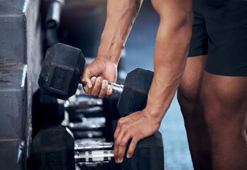Fototapeta na wymiar Closeup of man, workout and hands weightlifting with dumbbell in gym for health, fitness and muscle development. Strong, bodybuilder and exercise for sports, wellness and motivation in training club