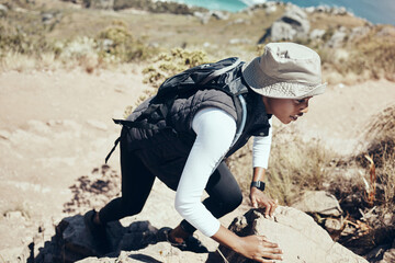 Woman, hiking and rock on mountain for climbing, workout or fitness. Girl, health and exercise for...