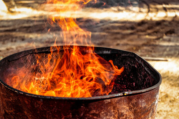 Burning fire in a barrel close-up. Bright flame. Open flame heating. Problems with heating and gas.